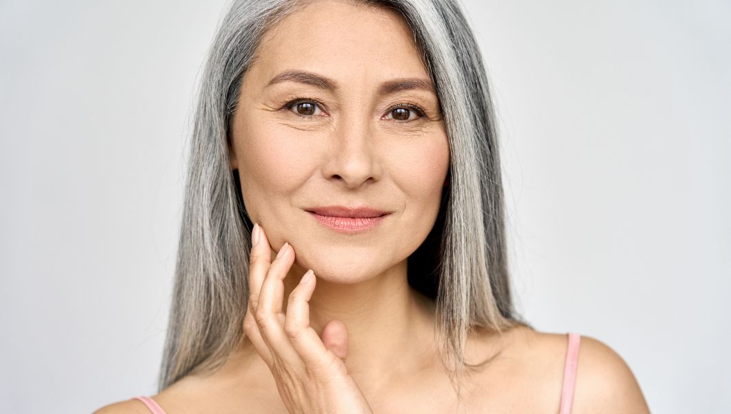 Nurturing Sensitive Skin Through Healthy Aging, beautiful older woman touching her face